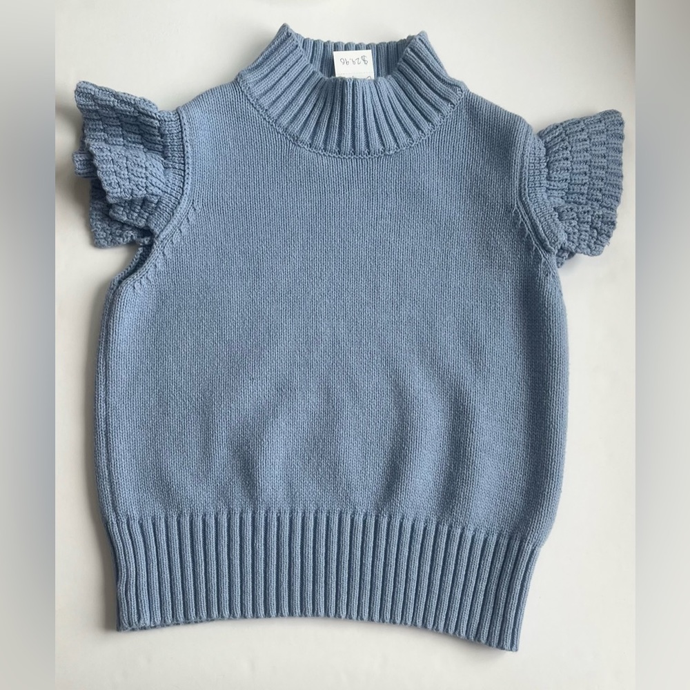 Blue knit crop blouse with flair sleeves.